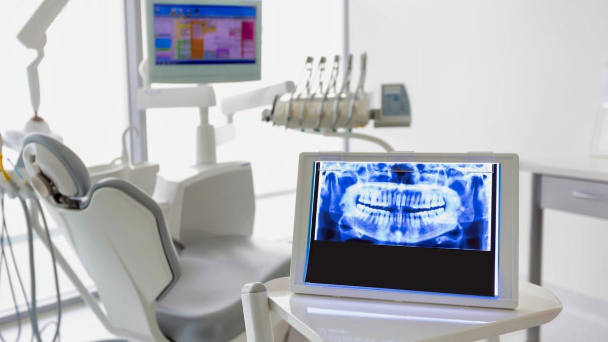 A surgical chair displaying a dental x-ray